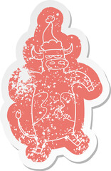 cartoon distressed sticker of a bull wearing santa hat