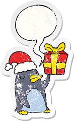 cartoon penguin and christmas present and speech bubble distressed sticker