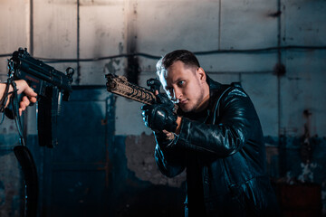 Fototapeta na wymiar A person with a weapon. Character from the comic book The Punisher. Armed with a pistol and machine gun. A dangerous person who solves problems with force.