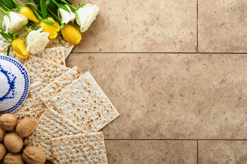 Passover celebration concept. Matzah, kosher red wine, walnut and white and yellow roses....