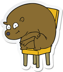 sticker of a cartoon bear sitting on chair