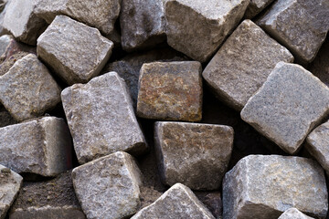 A pile of old large gray stone blocks.
