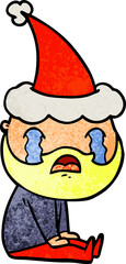 textured cartoon of a bearded man crying wearing santa hat