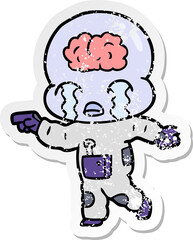 distressed sticker of a cartoon big brain alien crying