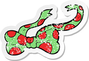 retro distressed sticker of a cartoon bow tie