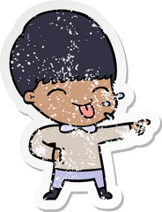 distressed sticker of a cartoon boy sticking out tongue