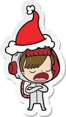 sticker cartoon of a astronaut woman explaining wearing santa hat
