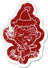 cartoon distressed sticker of a suspicious monkey wearing santa hat