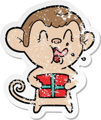 distressed sticker of a crazy cartoon monkey with christmas present