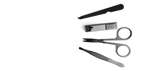 Banner of set of steel manicure and pedicure tools isolated on white with copy space. Classic metal kit of nail scissors, tweezer and manicure tools. Domestic nail beauty care objects.