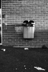 Trashcan with litter outside