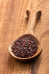 Brown quinoa seeds in spoon - Chenopodium quinoa