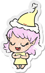 happy distressed sticker cartoon of a elf girl wearing santa hat