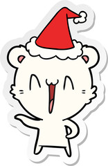 laughing polar bear sticker cartoon of a wearing santa hat