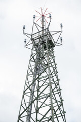Radar Tower with different measuring devices and sensors, low angle view during cloudy day, vertical shot