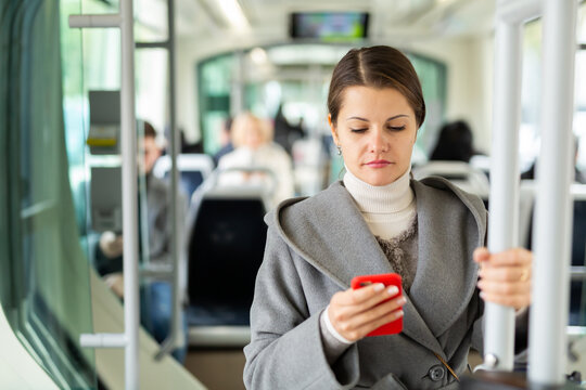 Woman with smartphone in bus. High quality photo