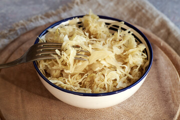 Fermented cabbage or sauerkraut with a fork