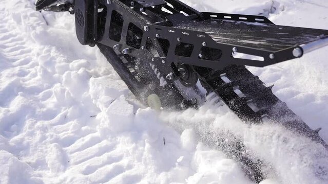 Snow motorcycle rides on snowdrifts. Snowbike skidding in the snow slow motion. Winter transport concept.