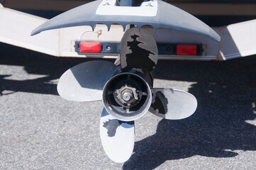 Outboard boat engine propeller isolated on land