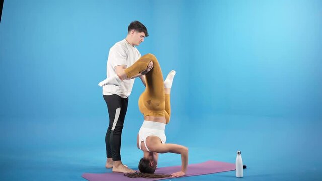 young caucasian girl doing yoga with instructor