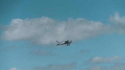 airplane flying in sky clouds blue vacation 