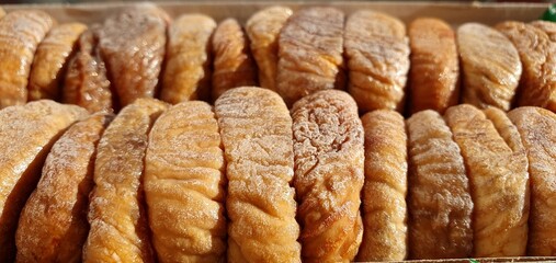 Dried figs in a box. Dried figs close-up. Sweet figs. Healthy sweets. Dry figs background and texture. Healthy dried fruits.