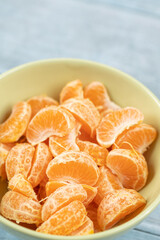 Tangerines in the bowl above dark blue food backgrounds