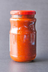  tomato sauce in a jar with fresh tomato on table 