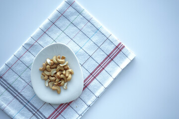 top view of cashew nut on a plate on table 