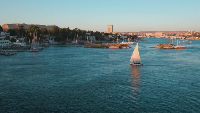 Nile river in Aswan, Egypt afternoon shot showing feluccas and boats in the river with elephantine Island (UNESCO World Heritage site)