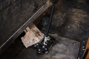 Car suspension repair. Hydraulic jack, car wheel replacement