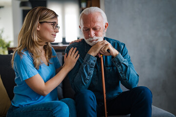 Young nurse spend time with old man, shares his pain, express empathy caring about 80s patient...