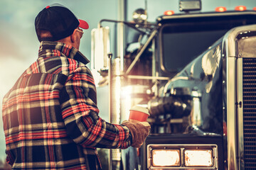 Semi Truck Driver Getting Ready For His Job Finishing His Cup of Coffee