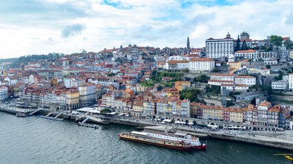 Fototapeta na wymiar Oporto, Portugal. April 12, 2022: Aerial landscape of the Riviera neighborhood and Duero river