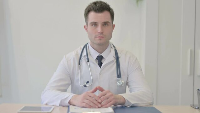 Young Doctor Looking at the Camera in Clinic