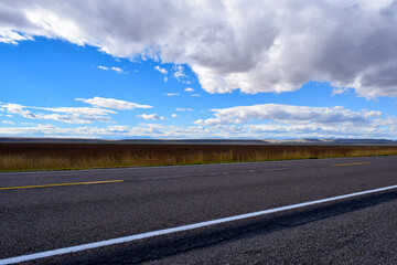 open road to the blue sky with clouds