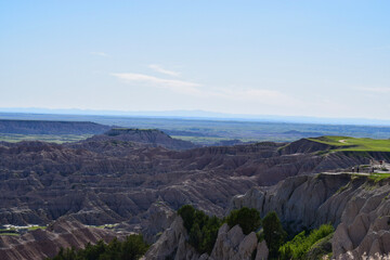 panorama of the mountains exposed rock with blue sky and green grass plateaus badlands