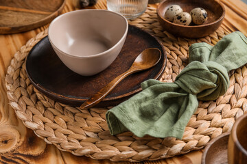 Beautiful table setting with plates, bowl and quail eggs on wooden background