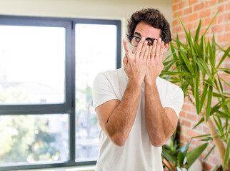 young adult crazy man with expressive pose at a modern house interior