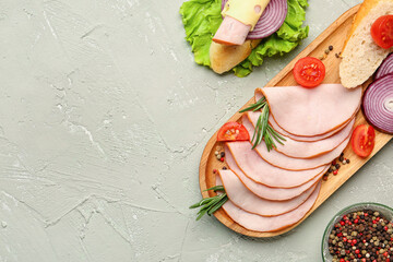 Board with ingredients for ham sandwich on grey grunge background