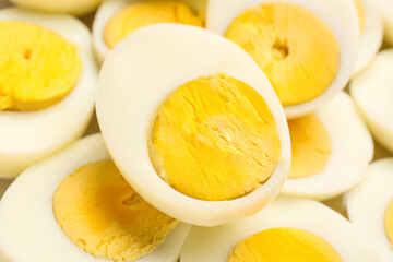 Halves of delicious boiled eggs as background, closeup