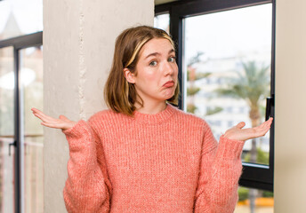 pretty caucasian woman feeling puzzled and confused, doubting, weighting or choosing different...