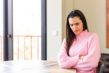 pretty caucasian woman feeling displeased and disappointed, looking serious, annoyed and angry with crossed arms