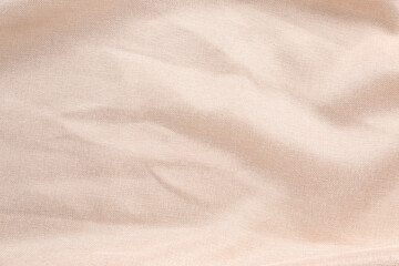 Fototapeta na wymiar Closeup view of crumpled beige fabric as background