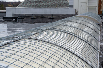 Barrel vault skylight screen fall protection guard installed on a commercial, industrial, or school skylight.   - Powered by Adobe
