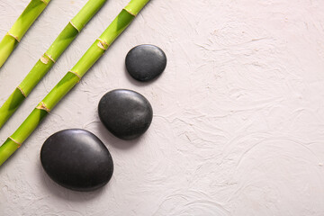 Obraz na płótnie Canvas Spa stones and bamboo on light background, top view