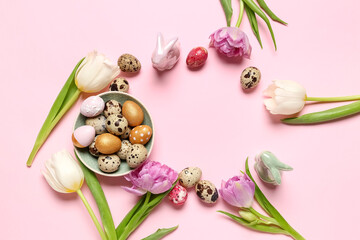 Frame made of Easter quail eggs and tulip flowers on pink background