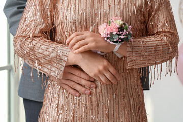 Young woman with corsage and her prom date hugging, closeup - obrazy, fototapety, plakaty