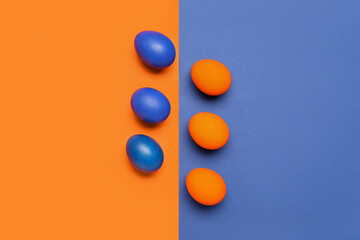 Painted Easter eggs on blue and orange background