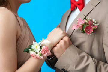 Young girl with corsage and her prom date on blue background, closeup - obrazy, fototapety, plakaty